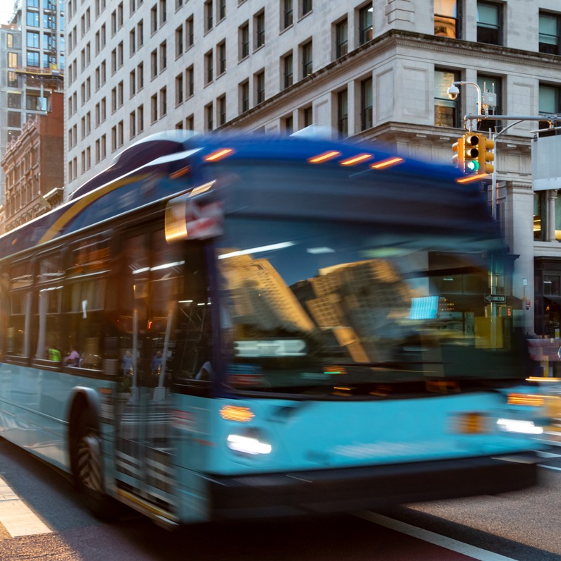 Transit bus in motion on a city street